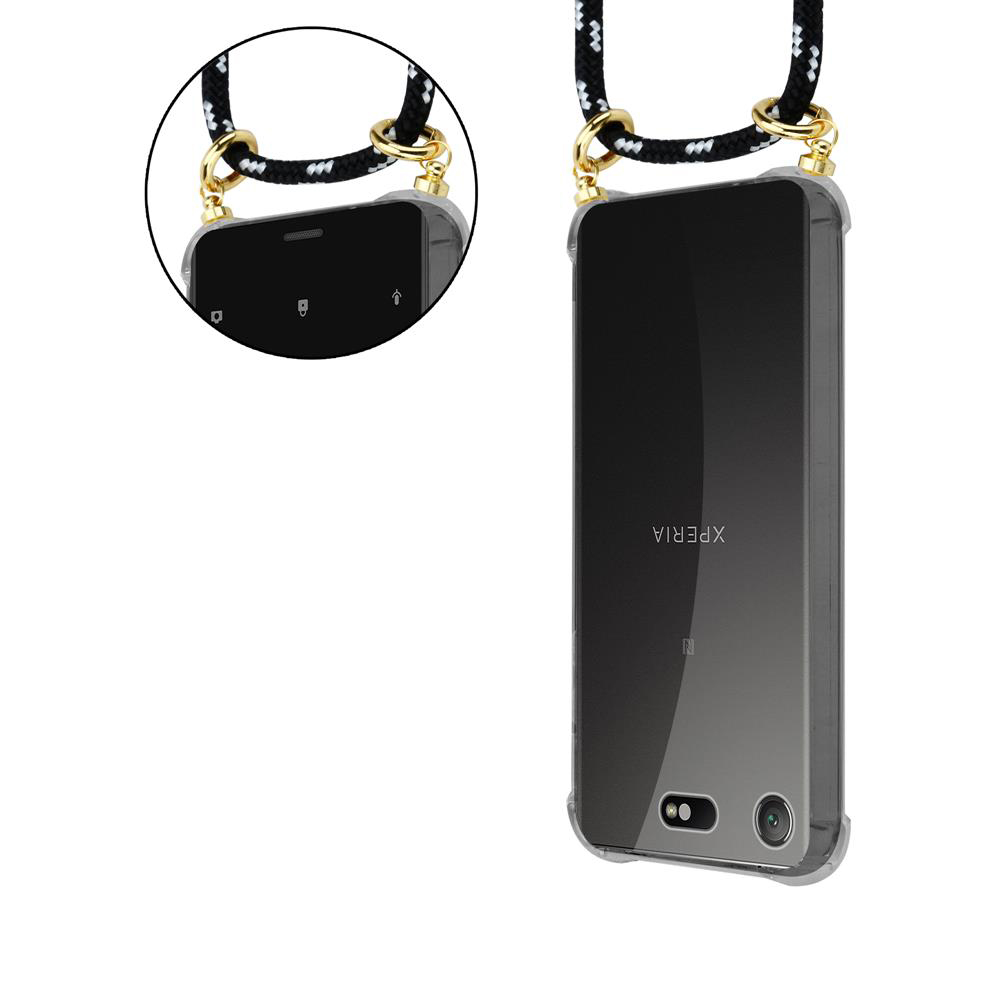 Ein Smartphone mit einer schwarzen Schnur und goldenen Beschlägen, auf weißem Hintergrund.