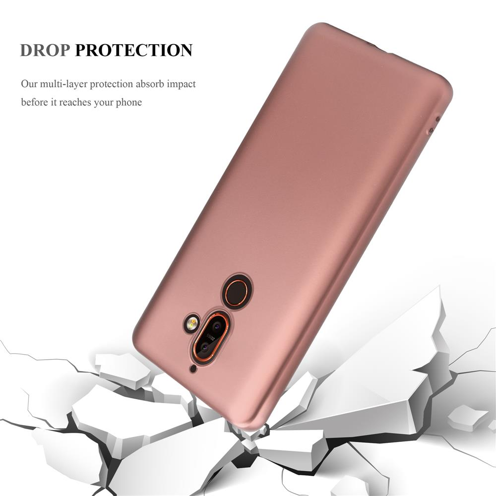 Ein roségoldenes Handycover fällt auf zerbrochene weiße Oberflächen.