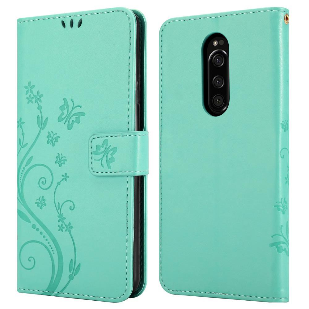 Custodia per telefono azzurra con motivo a farfalla e modulo fotocamera.