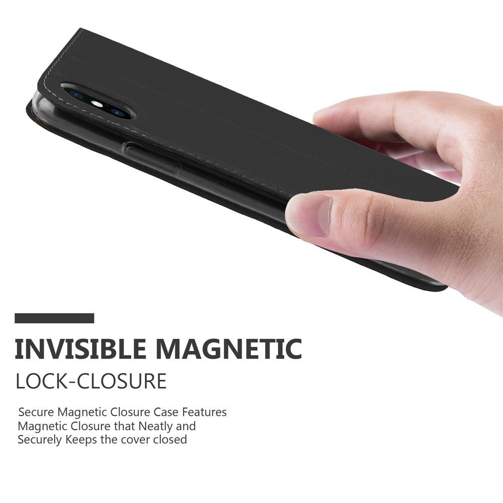 Mano che tiene una custodia a libro nera con chiusura magnetica.