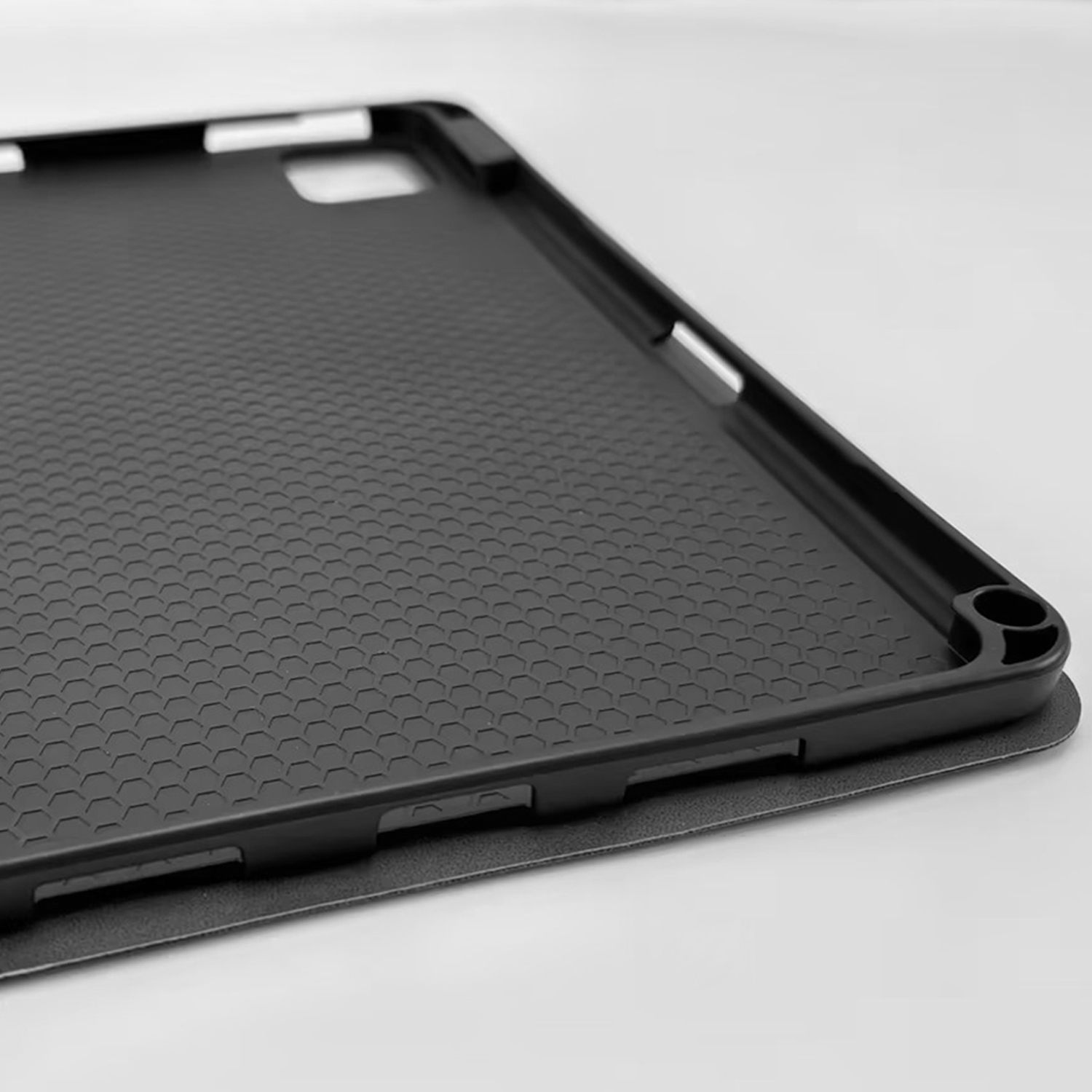 Black tablet case with honeycomb pattern interior and cutouts.
