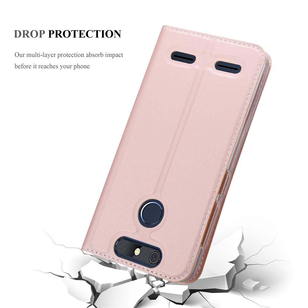 Una funda de teléfono rosa dorado descansa sobre suelo agrietado, mostrando su cámara y sensor.