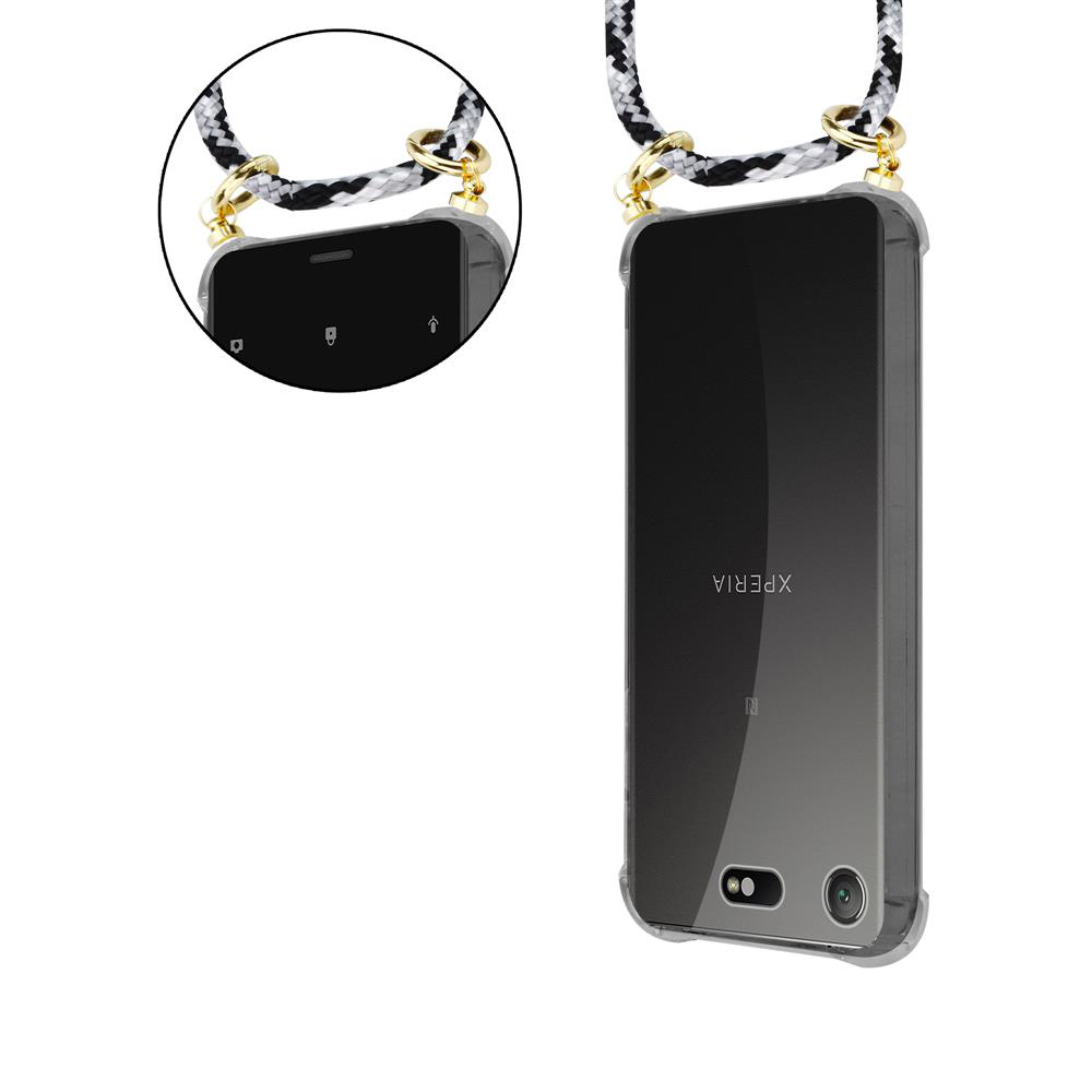 Ein Smartphone mit schwarzem und weißem Band, das an einem transparenten Gehäuse befestigt ist.