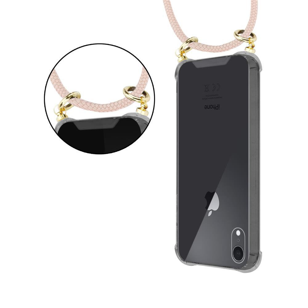 Una cover trasparente per telefono con cinturino rosa chiaro e anelli dorati.