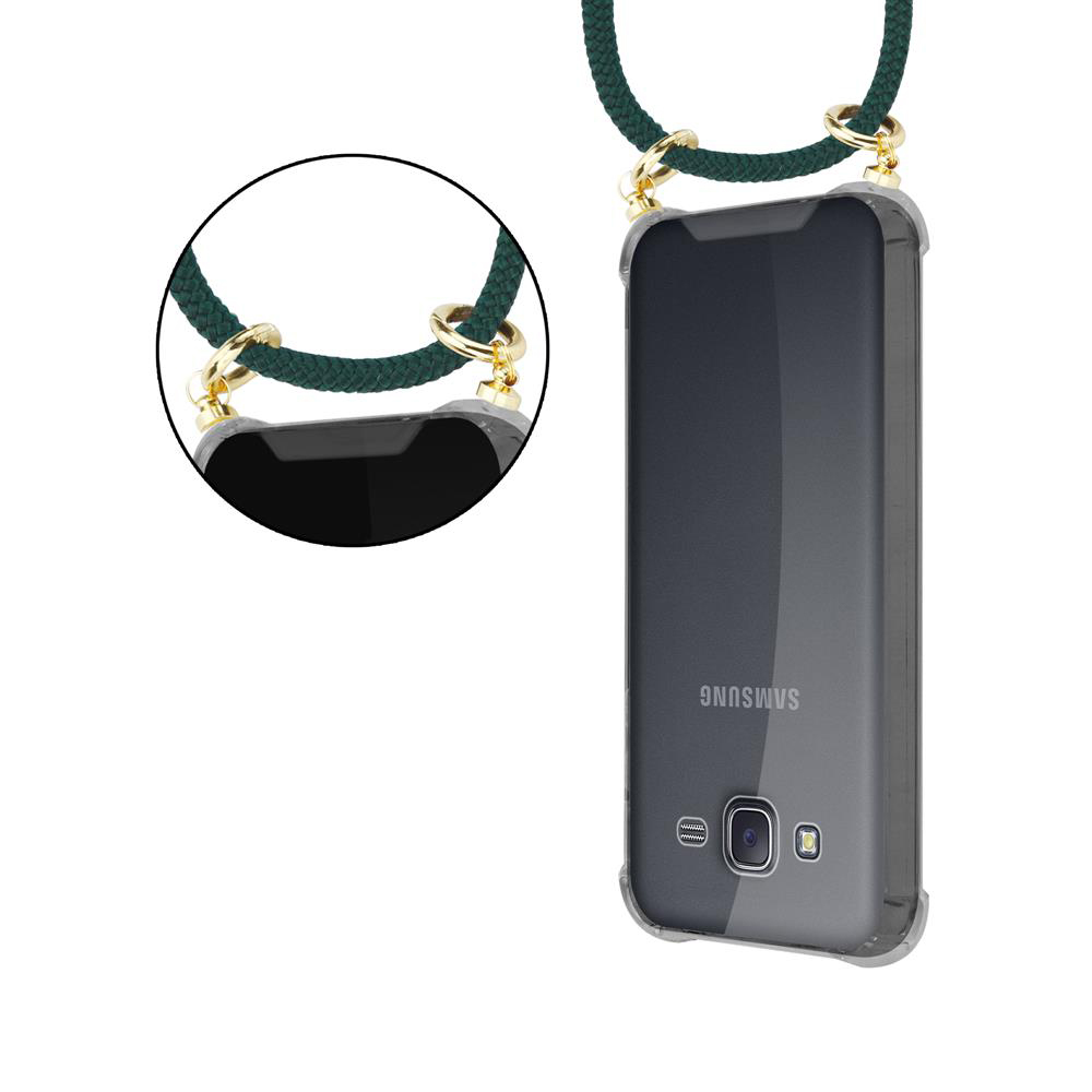 Laccio verde scuro con anelli dorati attaccato a un telefono Samsung trasparente.