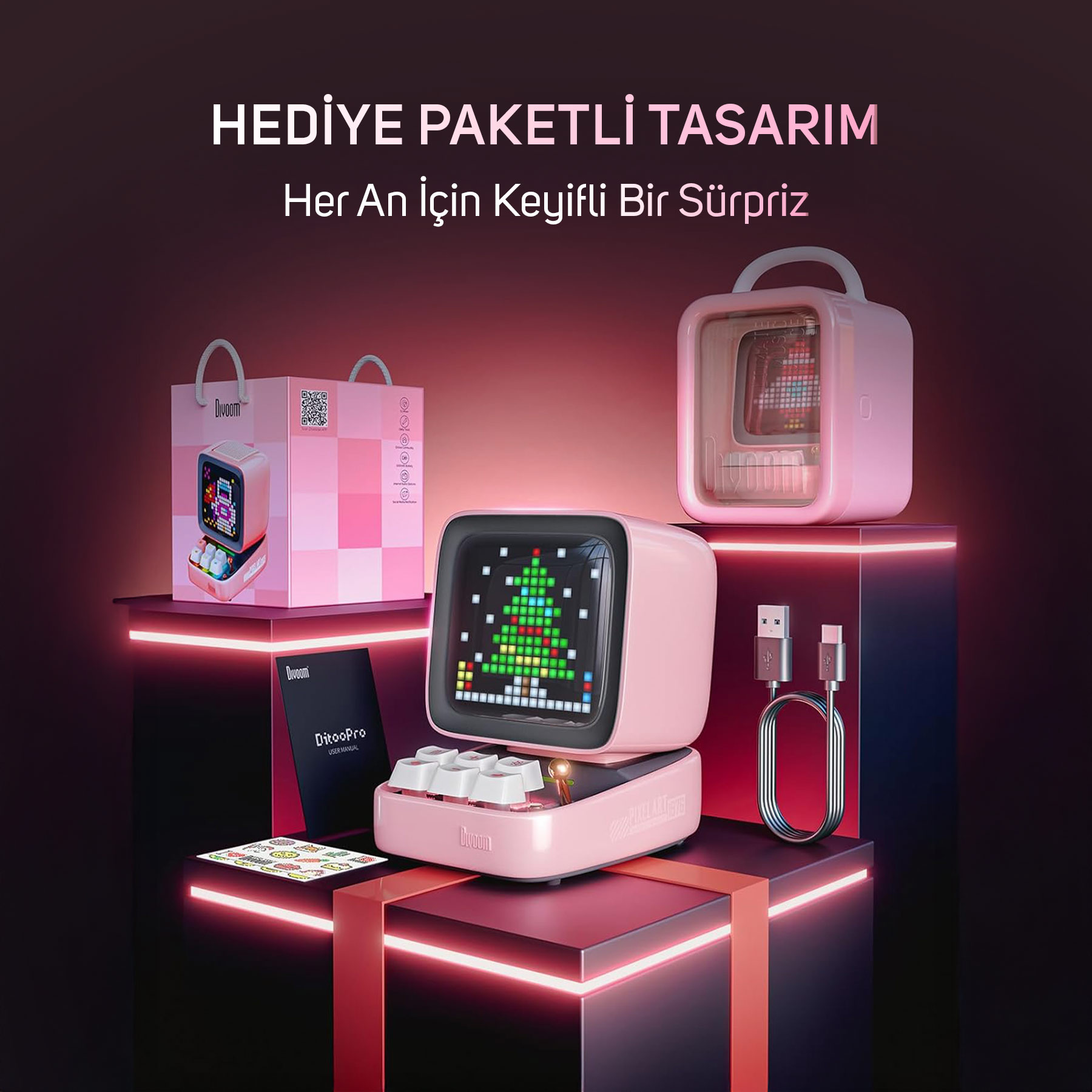 Altoparlante rosa con schermo pixel art, confezione regalo, cavo di ricarica e manuale.