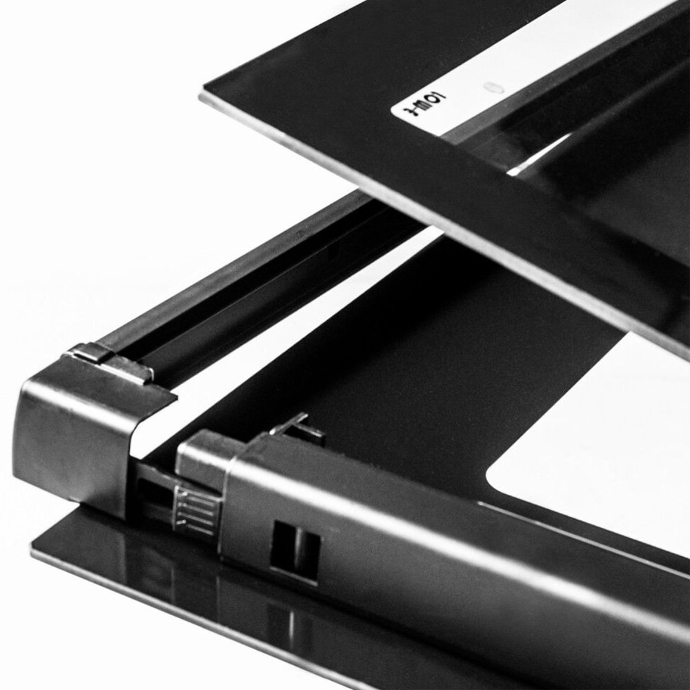 Close-up of a black metal frame with an open flap and label.
