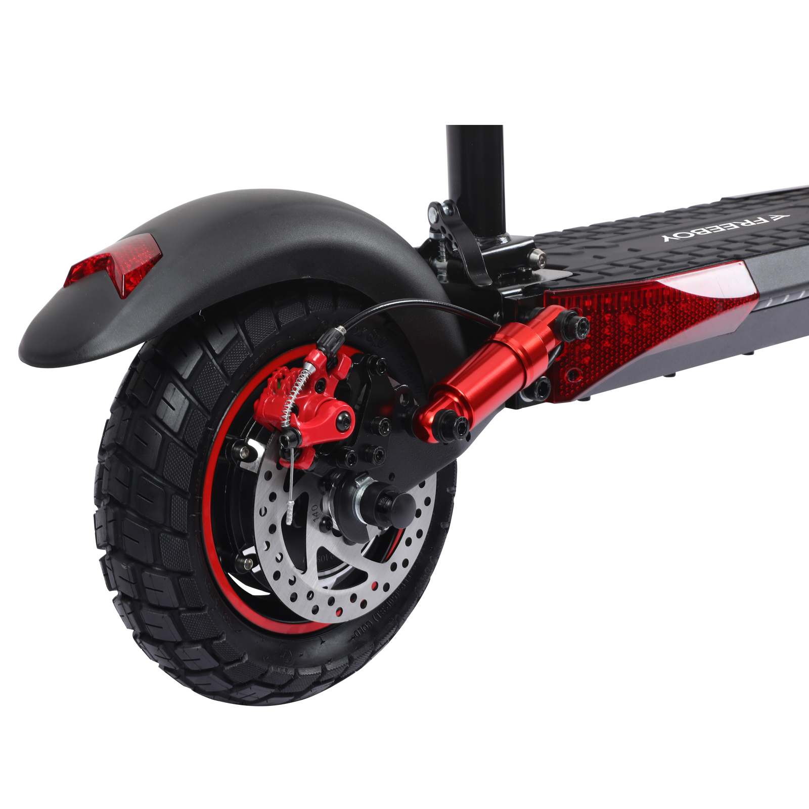 Zbliżenie tylnego koła hulajnogi elektrycznej z czarną oponą, czerwonymi hamulcami i amortyzatorem.