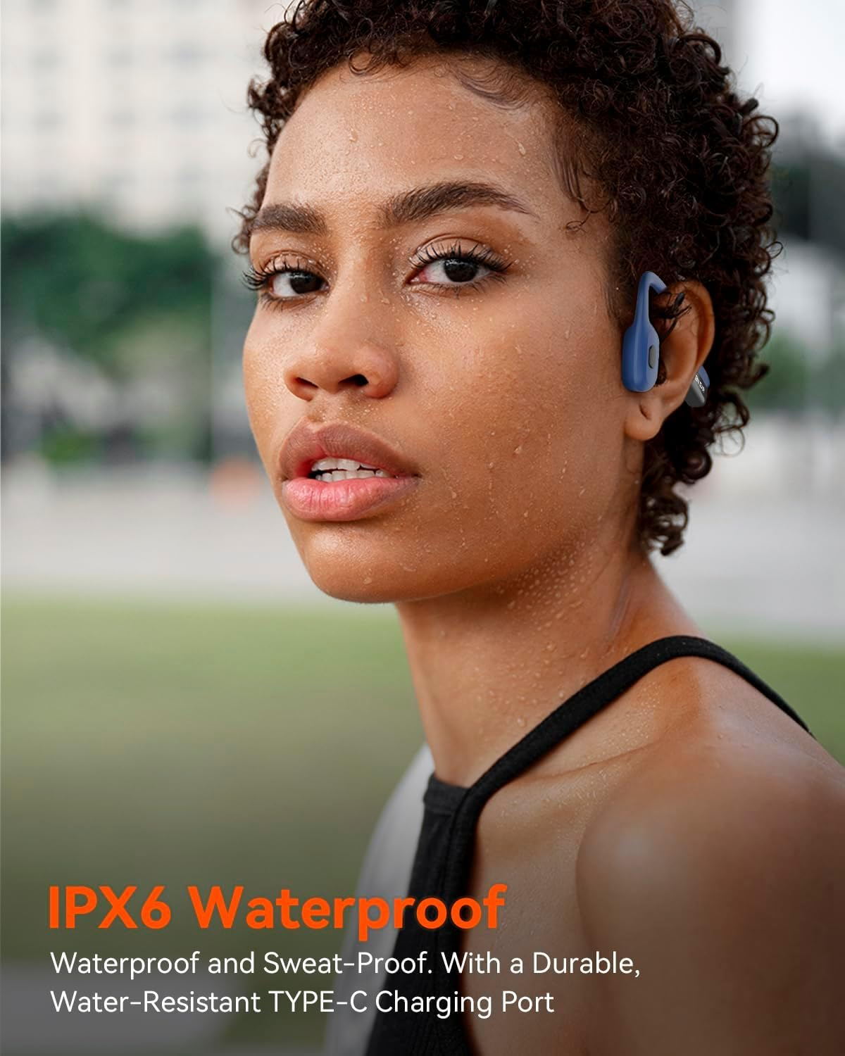 Mujer con auriculares azules, sudorosa. IPX6 impermeable.