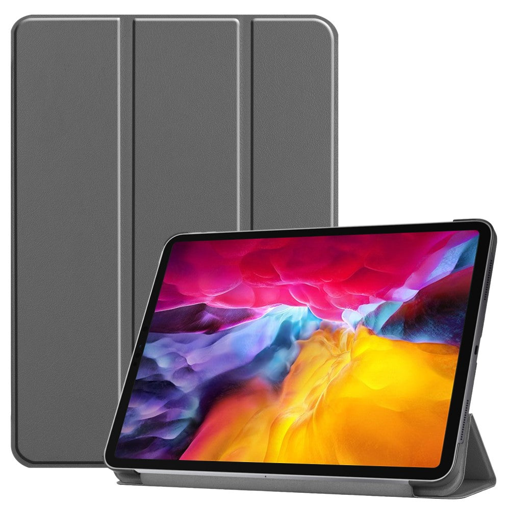 Graues Tablet mit Klapphülle und buntem Hintergrundbild.