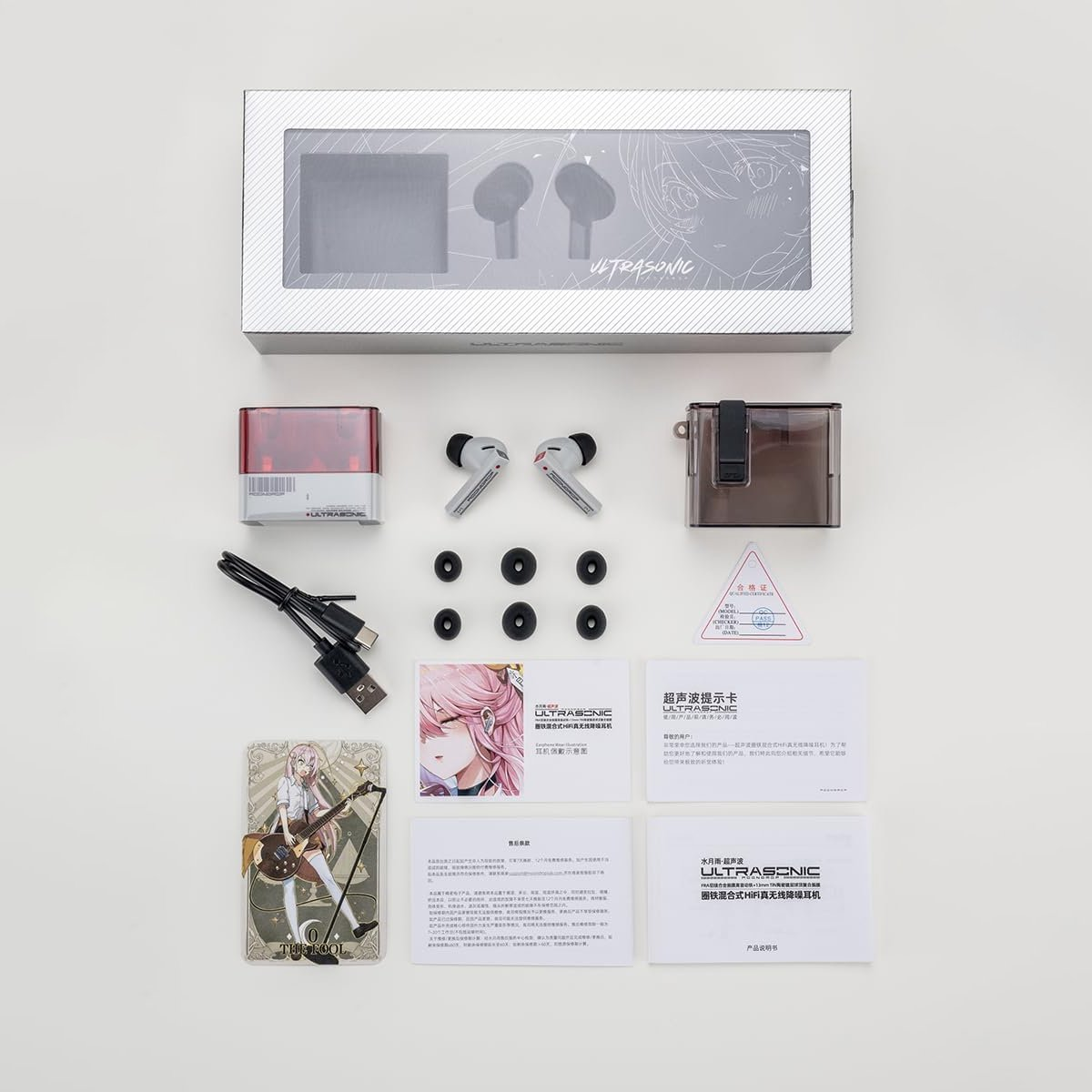 Headphone packaging with accessories: earbuds, cable, ear tips, manual, and card.