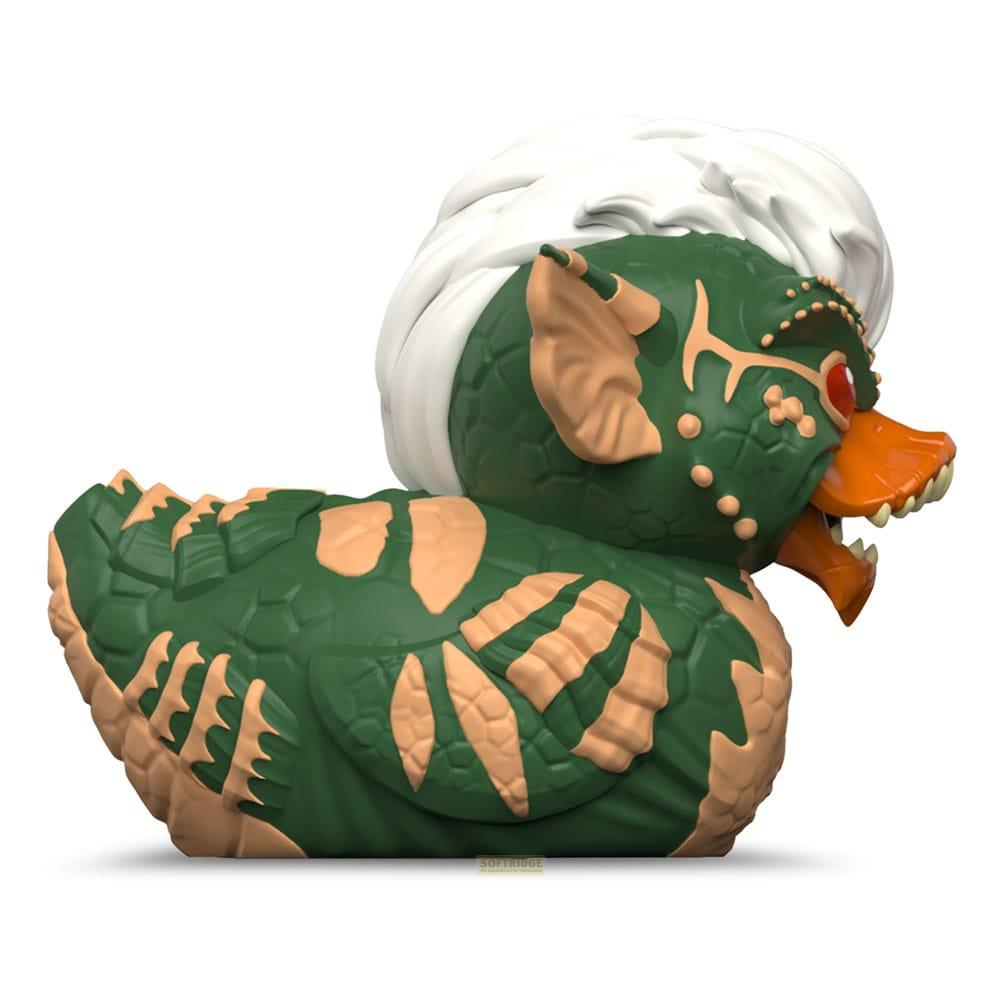 Grüne Gummi-Ente mit weißem Haar, orangefarbenem Schnabel und roten Augen.