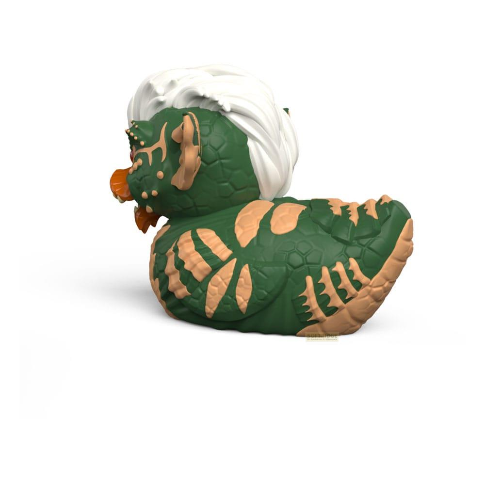 Grüne Gummi-Ente mit weißem Haar, orangefarbenem Schnabel und hellbraunen Flecken.