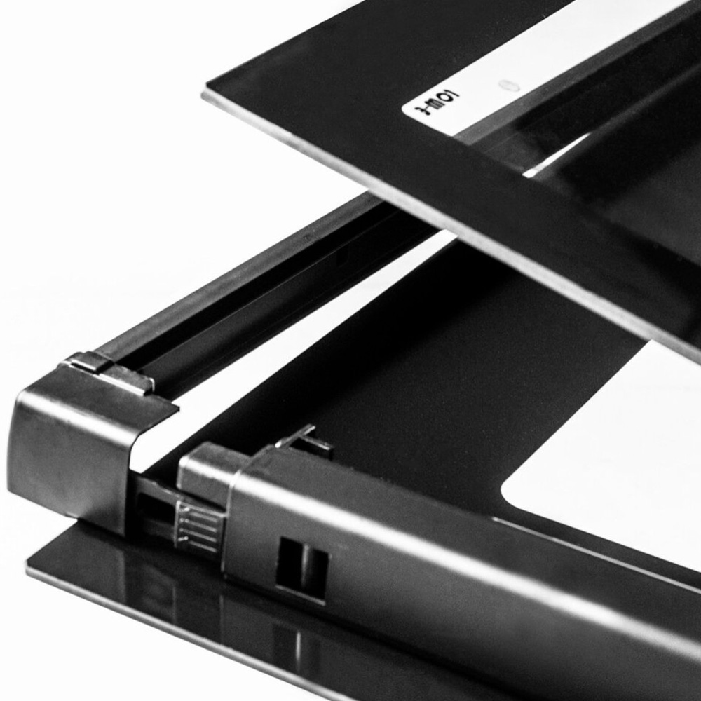 Close-up van een open scanner met zwart frame en metalen scharnieren.