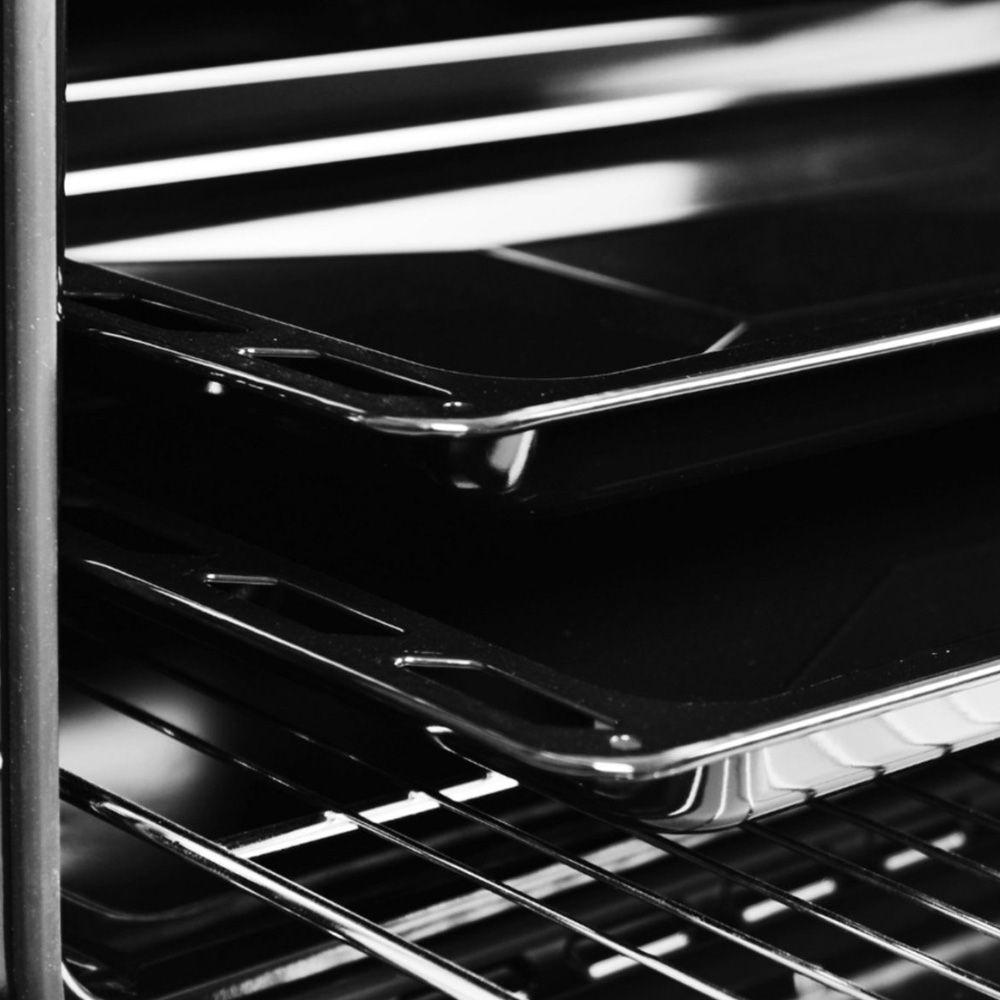 Close-up of two baking trays resting on racks inside an oven.
