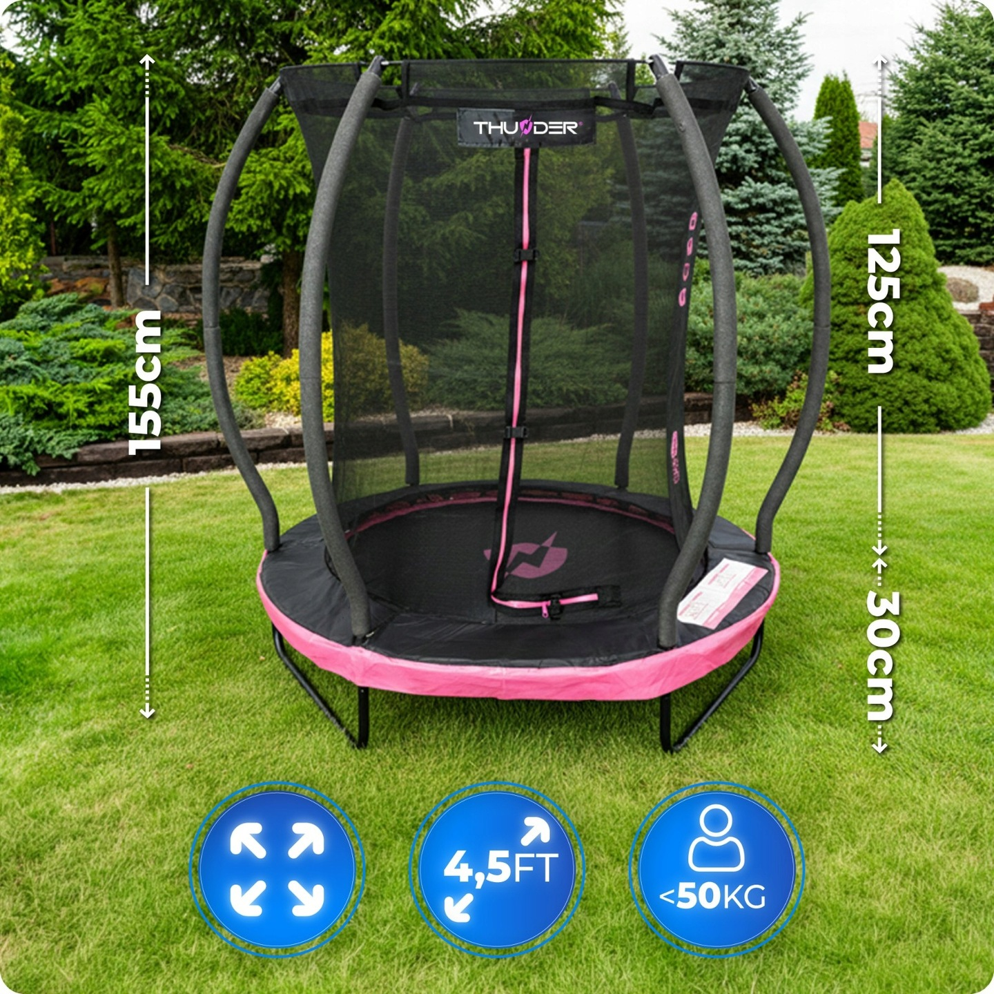 Trampolina z siatką i różową obwódką na trawie. Wymiary 155cm wysokość, 125cm średnica.