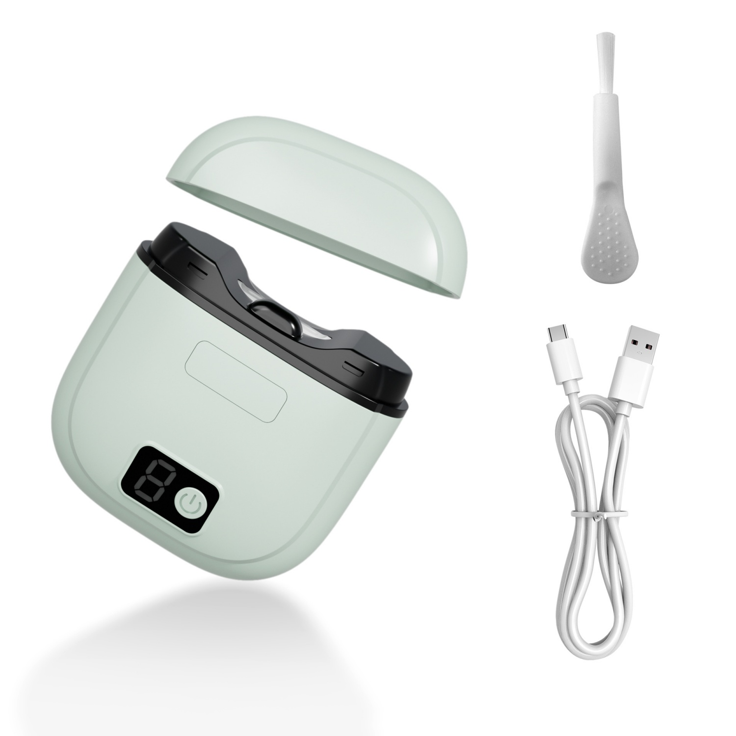 Ein hellgrünes Gerät mit offenem Deckel, Bürste und USB-Kabel.