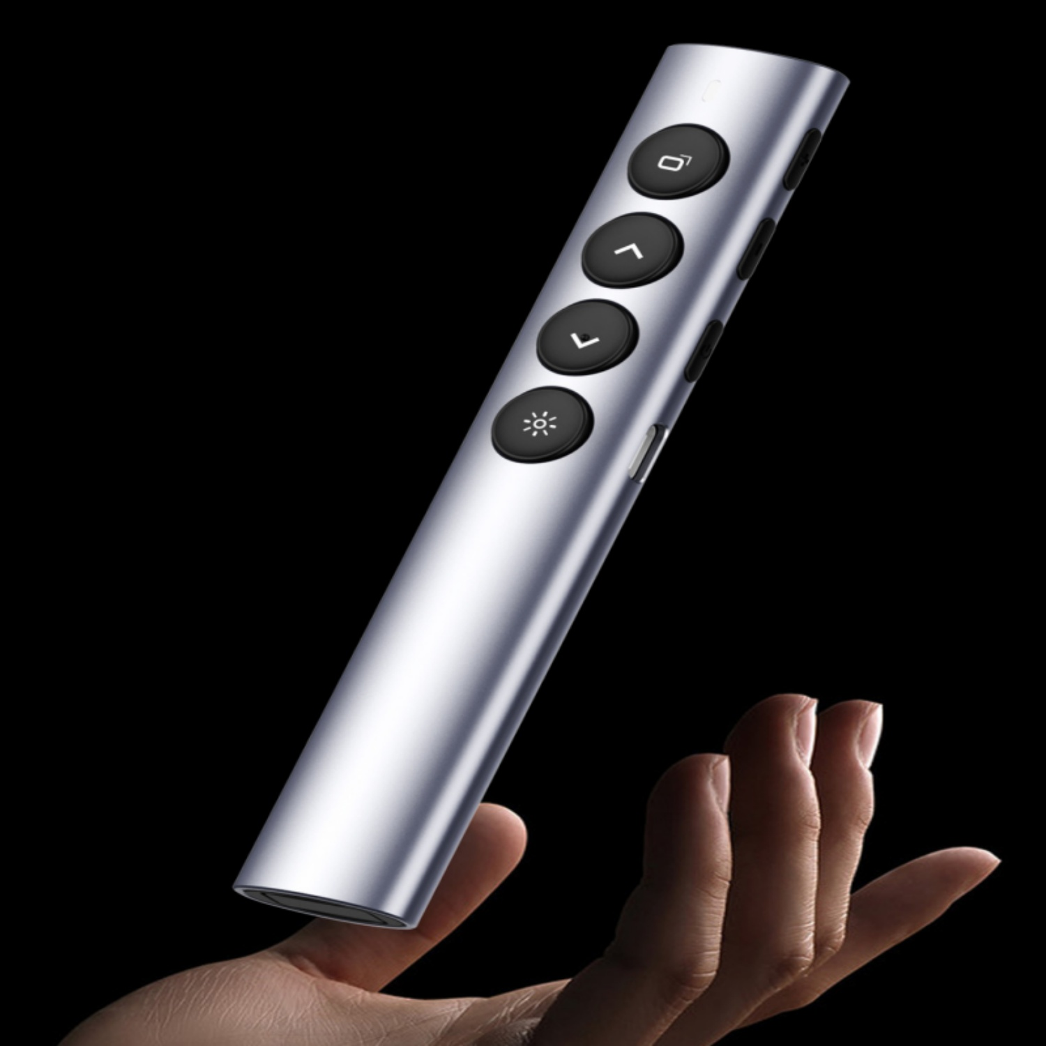 Silberner Presenter mit schwarzen Tasten auf schwarzem Hintergrund, gehalten von einer Hand.