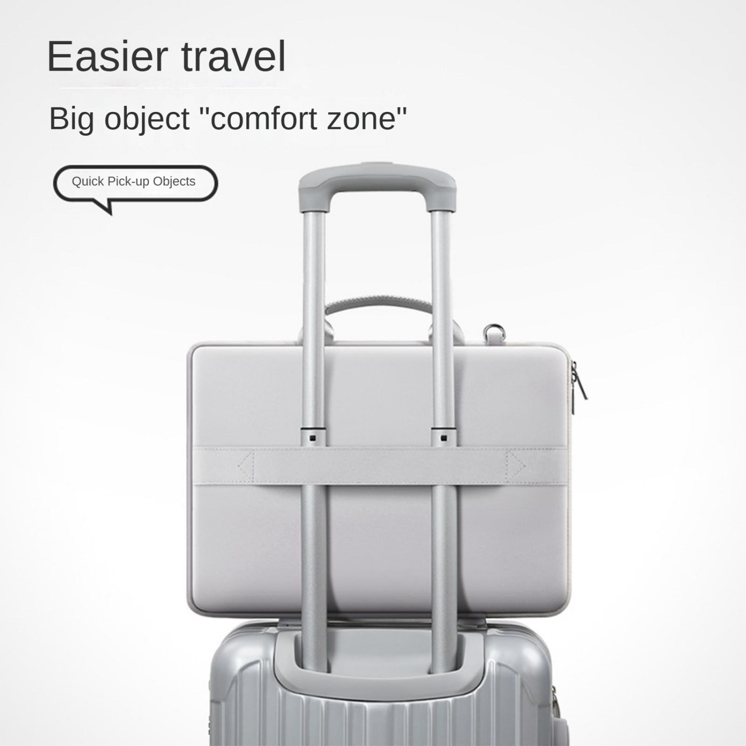 Ein silberner Koffer mit einer Laptoptasche darauf, befestigt an einem Teleskopgriff.