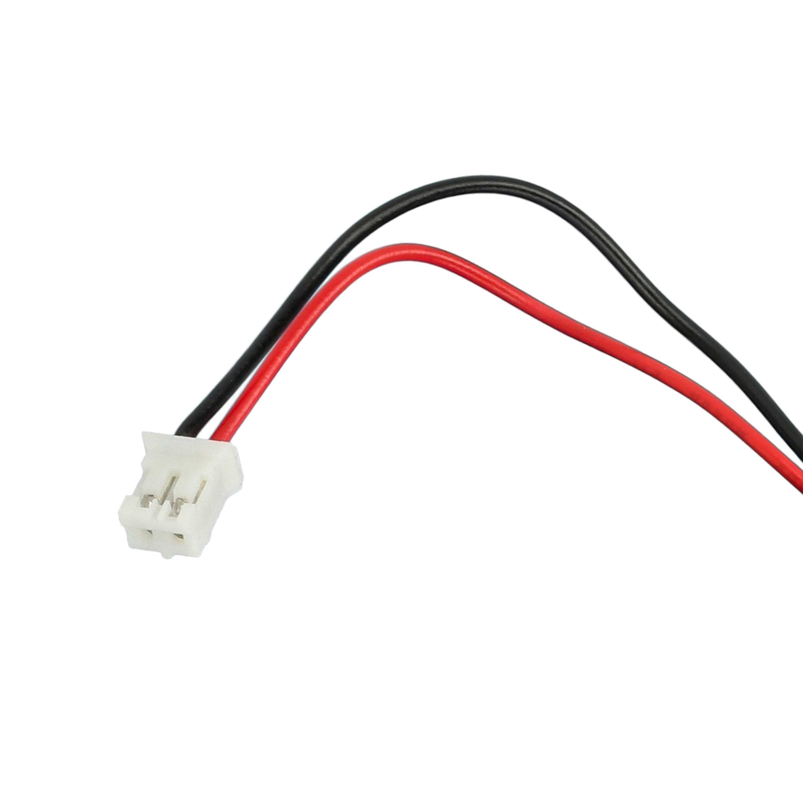 Ein weißer Stecker mit roten und schwarzen Kabeln.