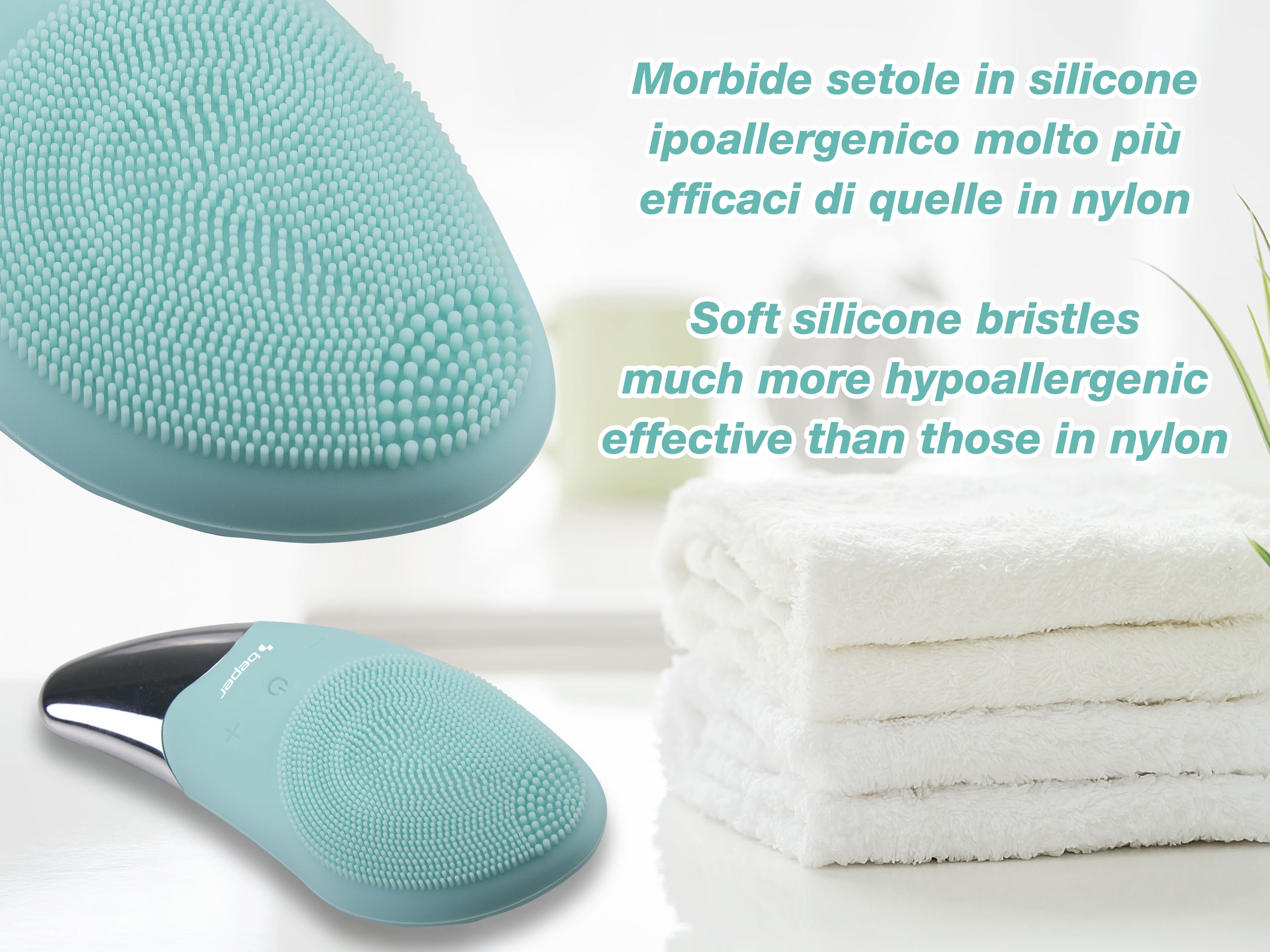 Un dispositivo per la pulizia del viso in silicone verde acqua accanto ad asciugamani bianchi.