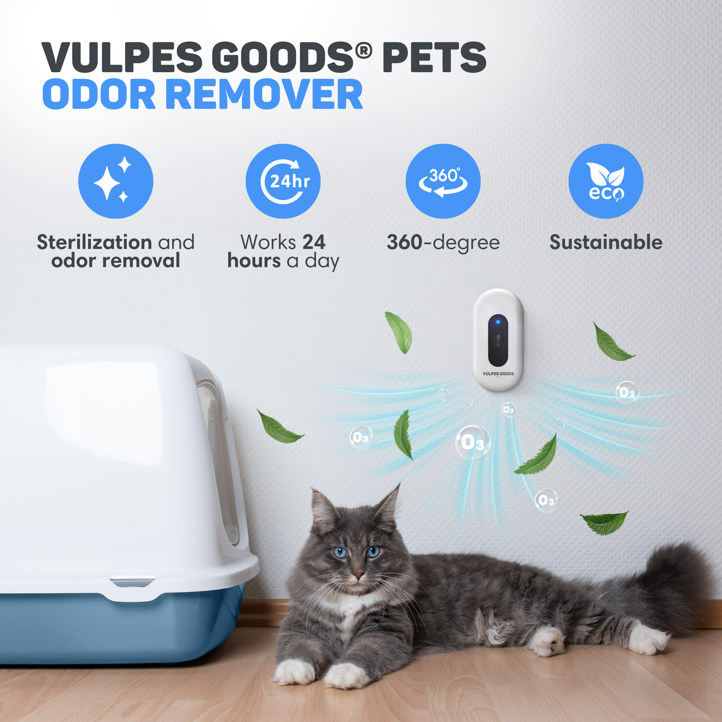 A gray cat lies near a litter box, an odor remover hangs on the wall.