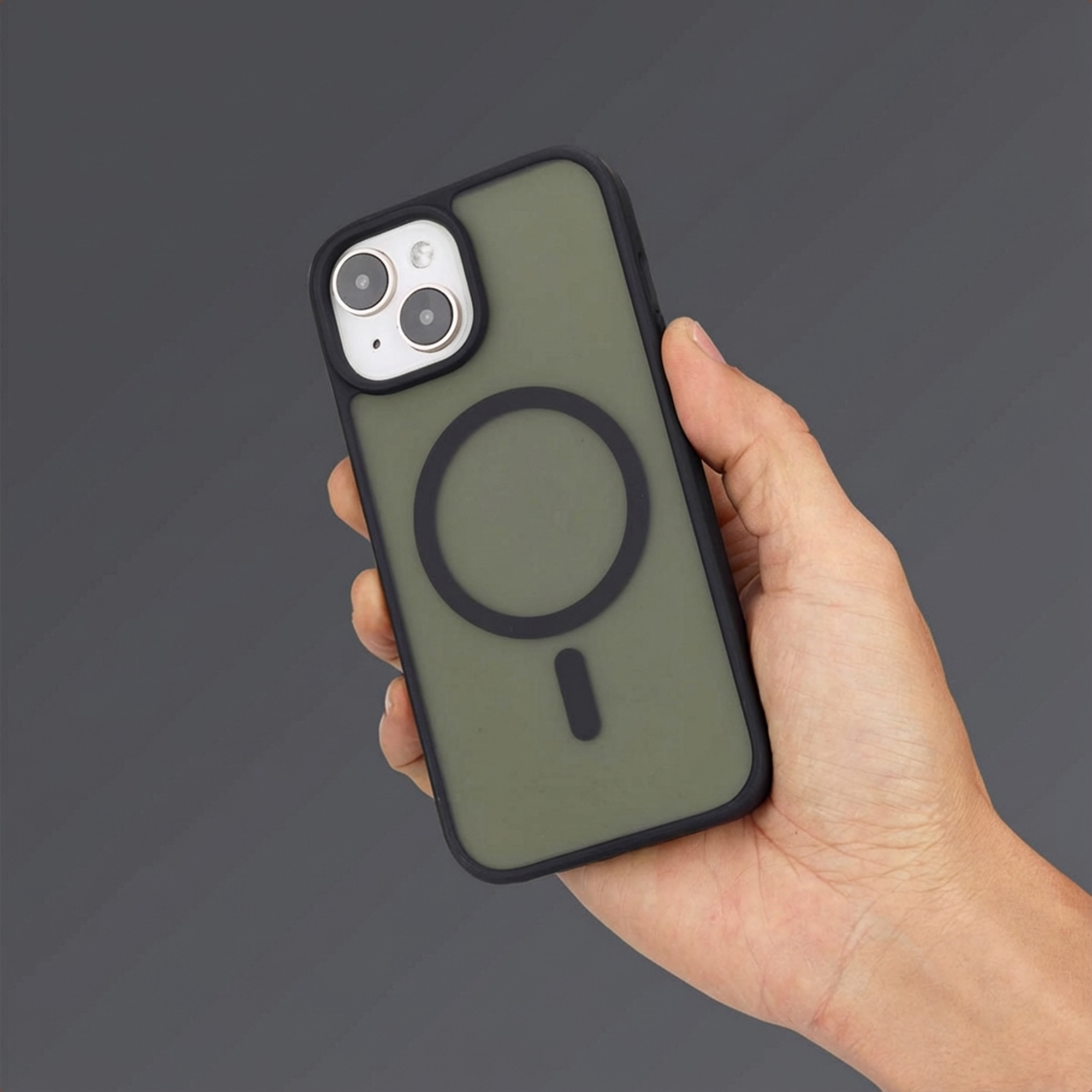 A hand holds a dark green iPhone case with a magnetic ring.