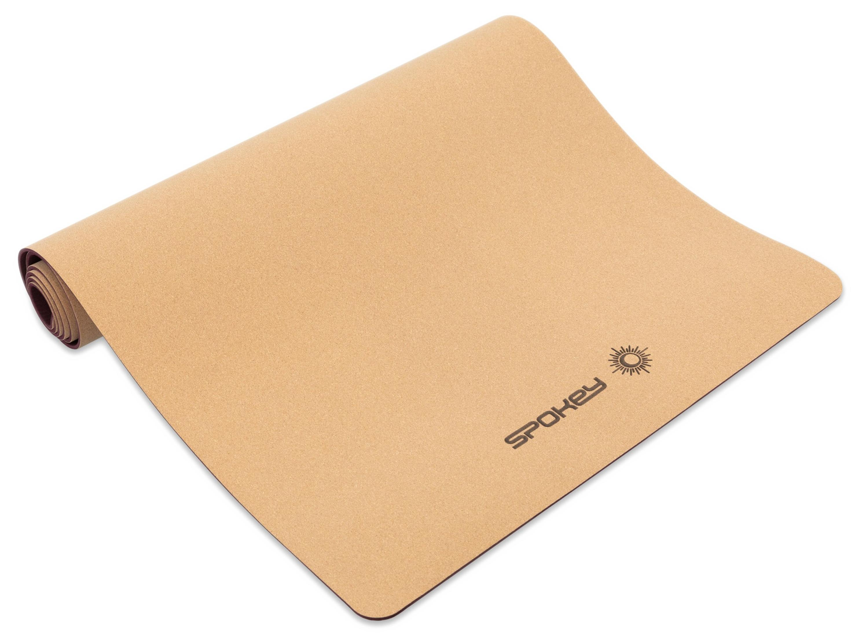 Brązowa mata do jogi z logo Spokey i symbolem słońca.