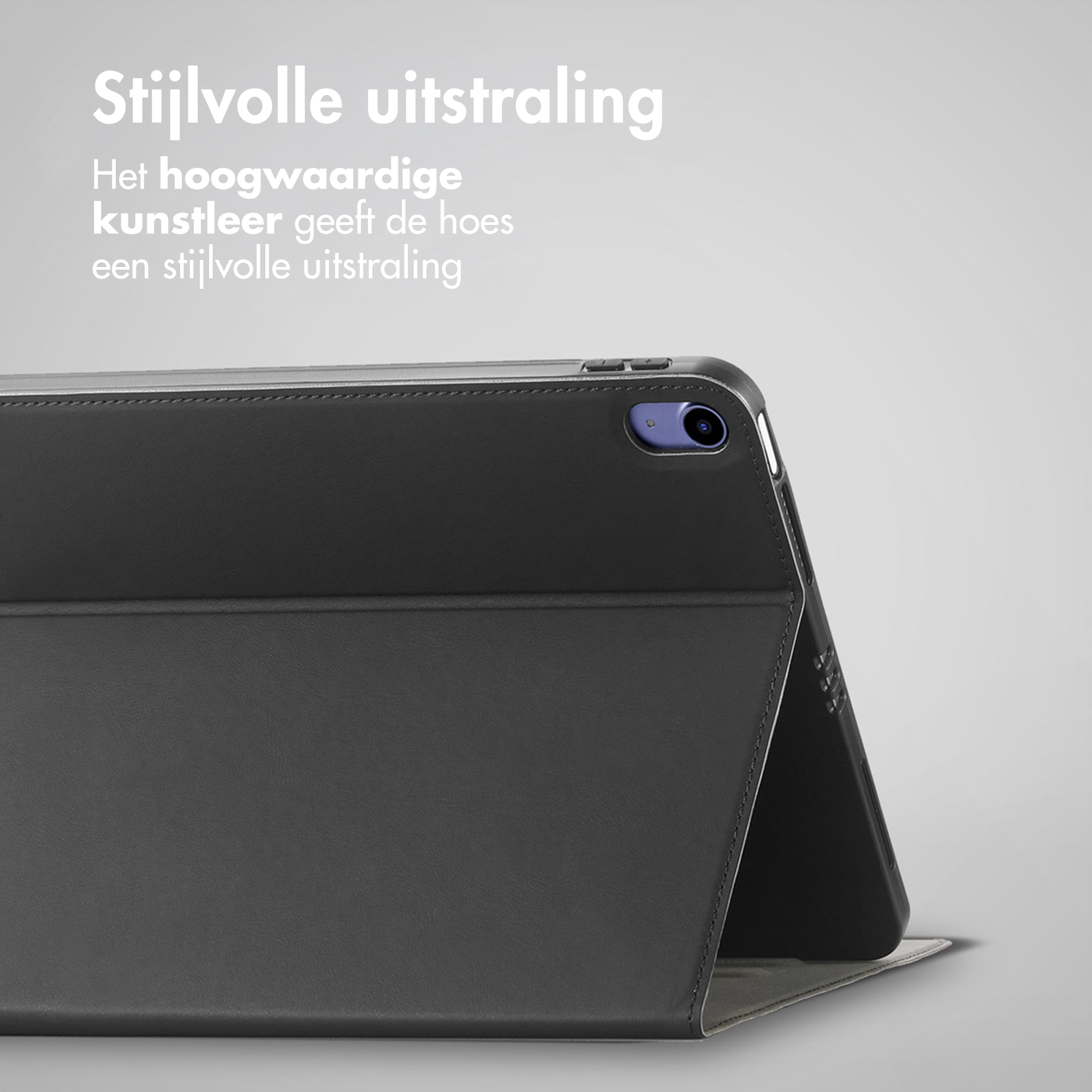 Une tablette noire avec un étui élégant sur fond gris.