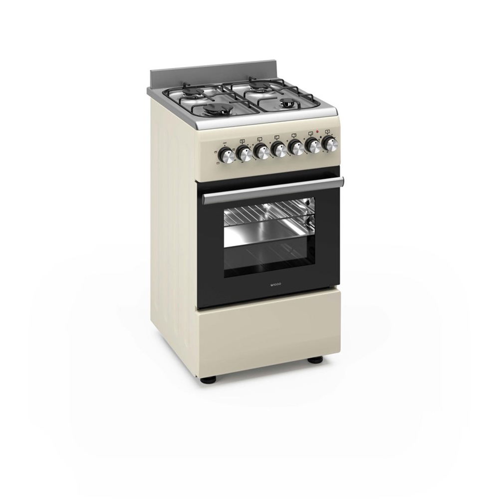 Une cuisinière à gaz crème avec quatre brûleurs, une porte de four noire et des boutons argentés.