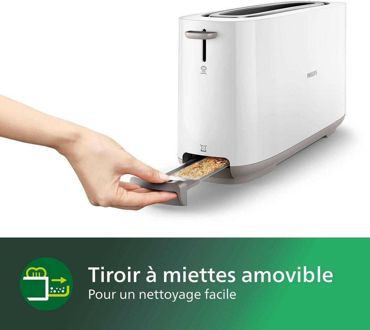 Eine Hand zieht eine Krümelschublade aus einem weißen Toaster.
