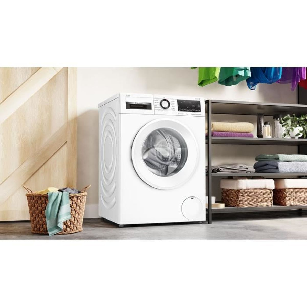 A white washing machine with a laundry basket beside it and shelves with towels.