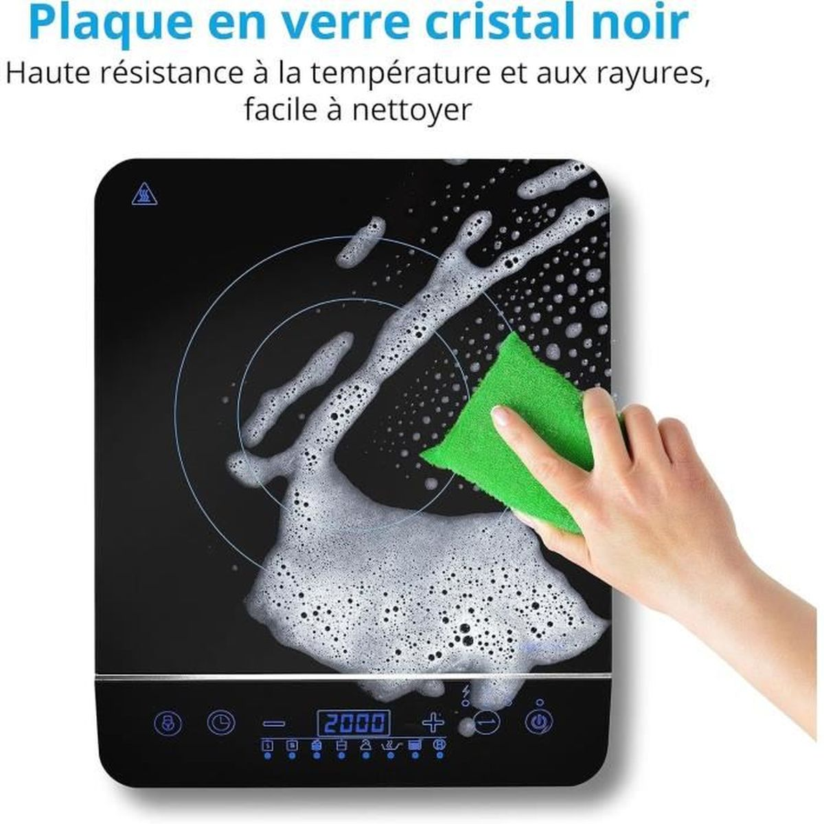 Dłoń czyści czarną płytę grzewczą zieloną gąbką i pianą.