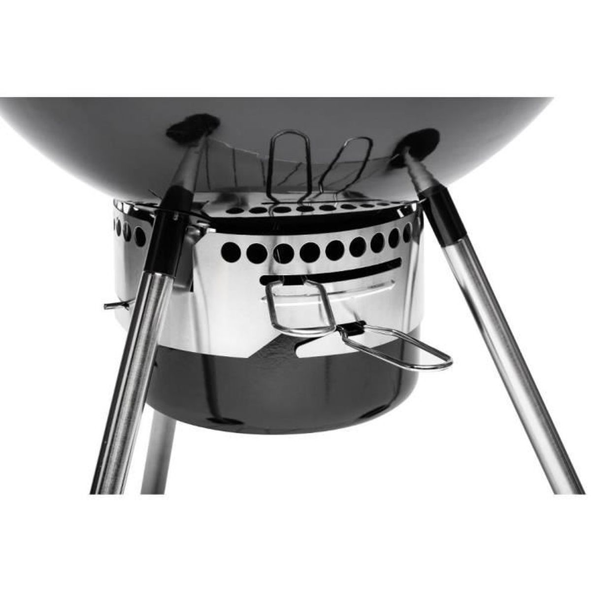 Close-up of a black kettle grill bottom with silver legs and vents.