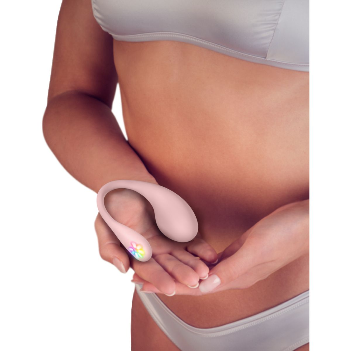 Eine Person hält einen rosafarbenen Vibrator mit bunten Lichtern in ihren Händen.