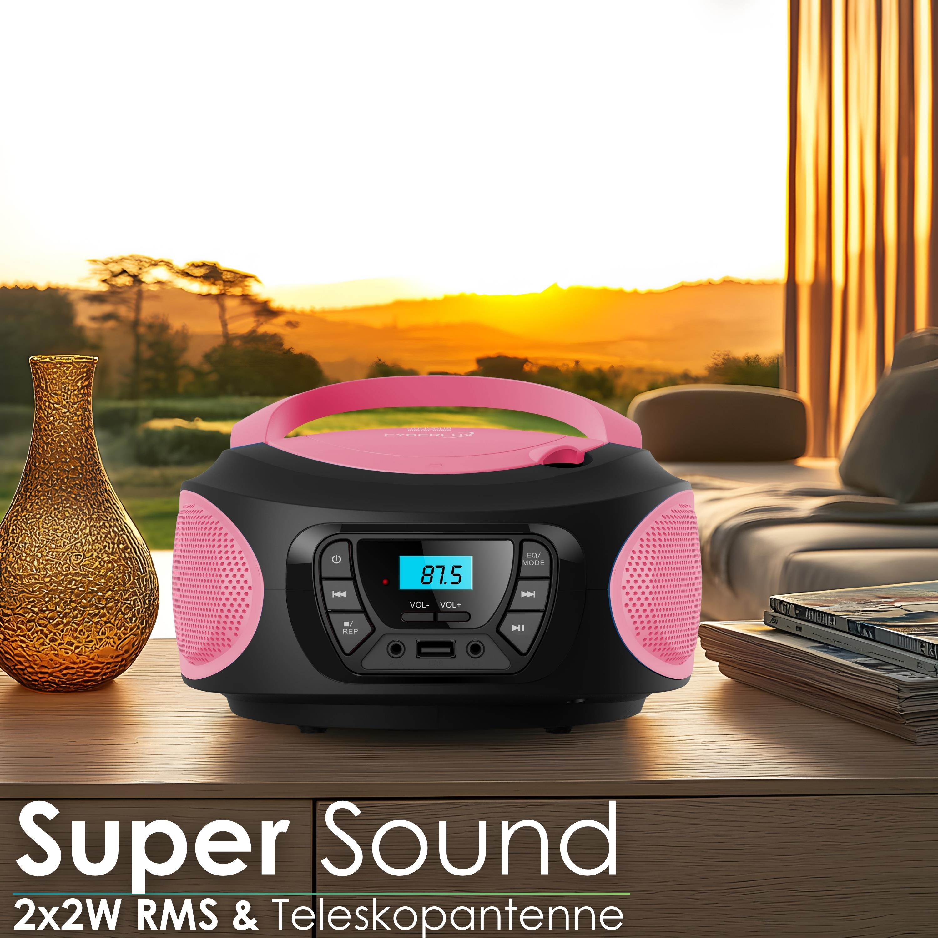 Ein pink-schwarzer CD-Player steht auf einem Tisch mit Blick auf einen Sonnenuntergang.
