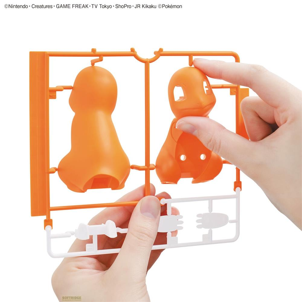 Orange Pokémon-Modellbausatzteile werden gehalten. Hände entfernen Teile.