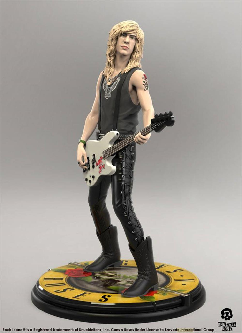 Statue eines Bassisten mit langen Haaren, der eine weiße E-Gitarre hält.