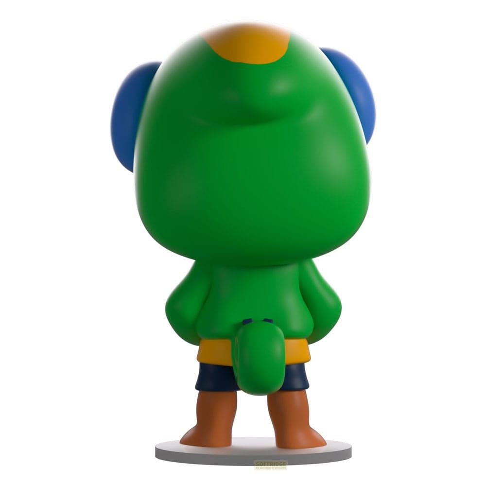 Grüne Figur mit blauen Ohren, gelbem Fleck, Shorts und braunen Füßen.