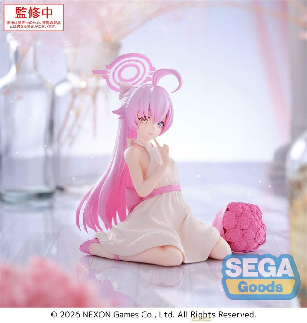 Eine rosa Haarfigur in einem weißen Kleid mit einem Blumenstrauß.