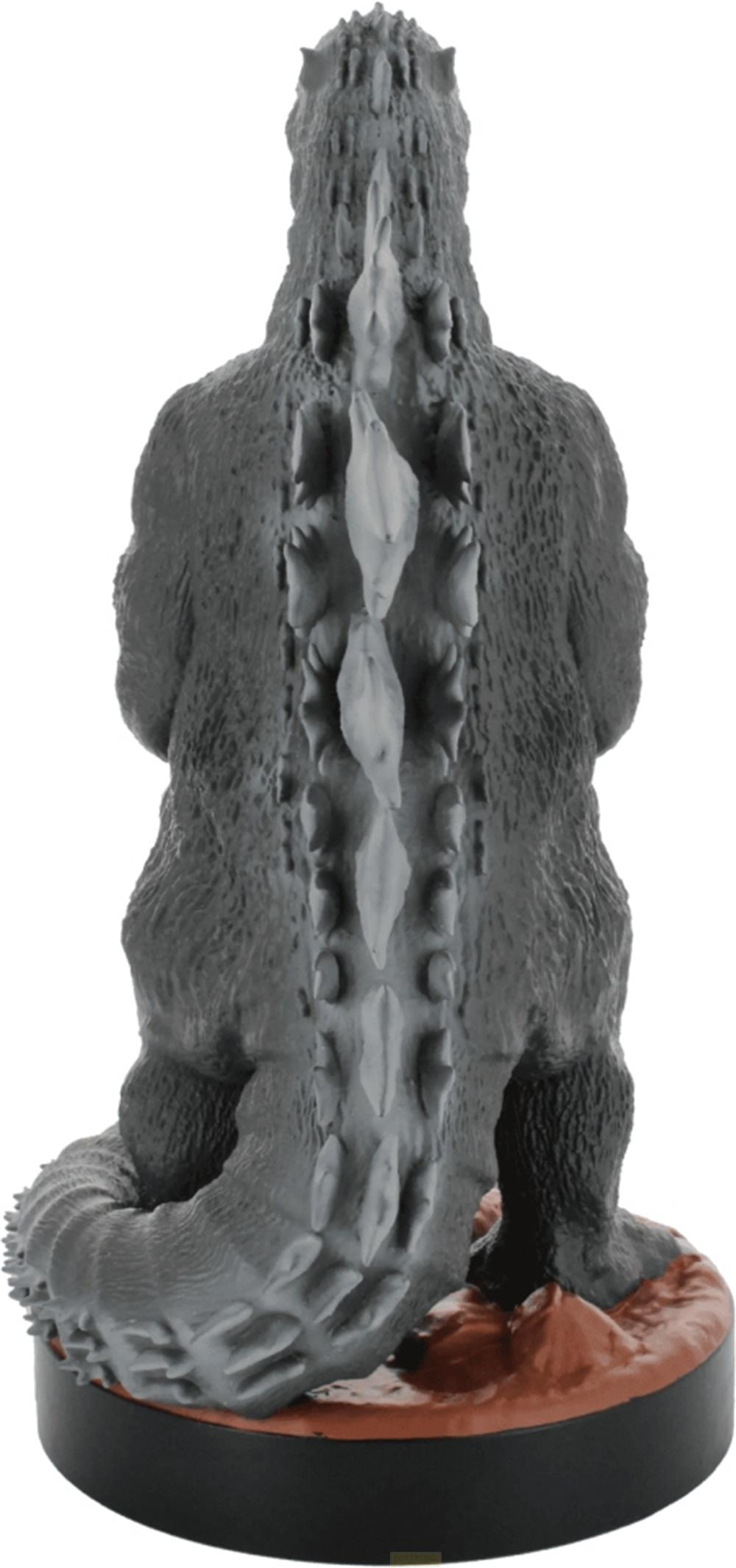 Graue Godzilla-Figur von hinten mit Rückenstacheln auf einem braunen Sockel.