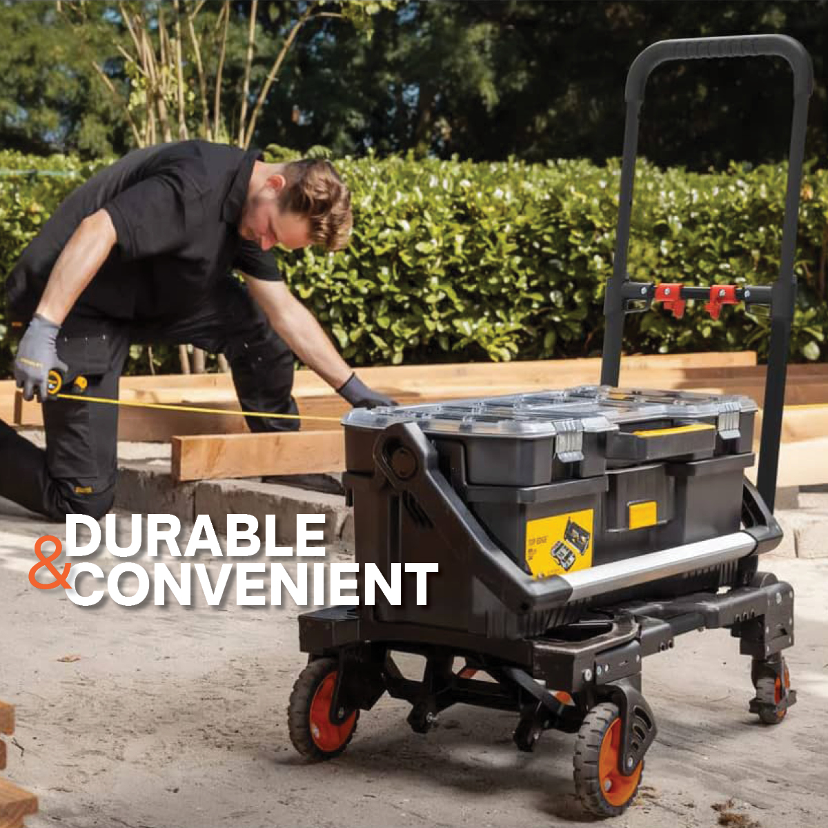 Man measures wood with tape measure next to a tool cart.