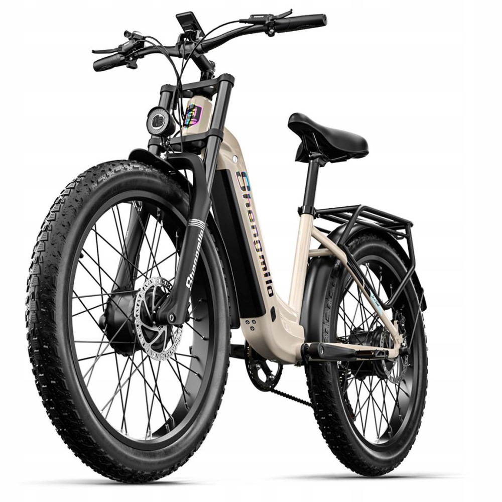 Una e-bike beige con pneumatici larghi, sella nera e portapacchi posteriore.