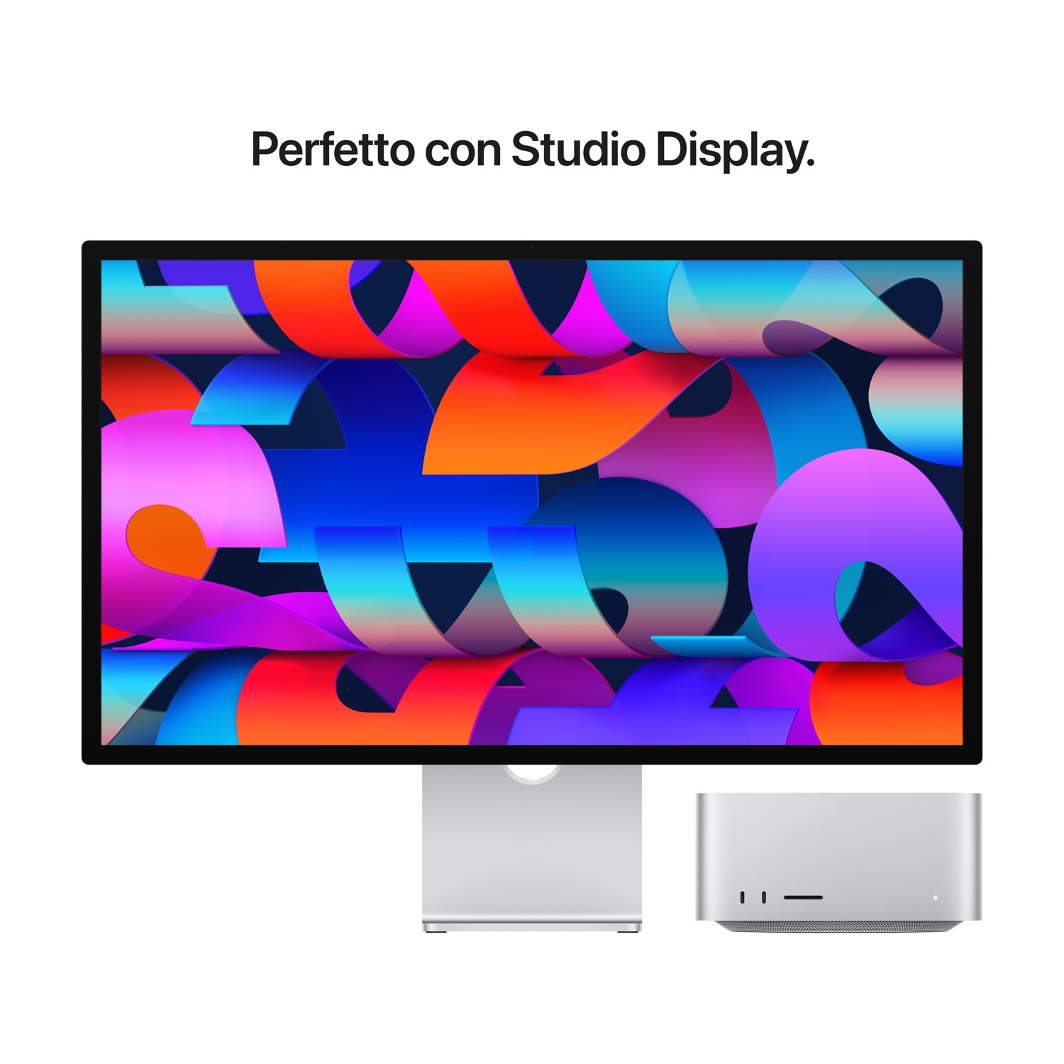 Un monitor con grafica colorata e un computer argentato.