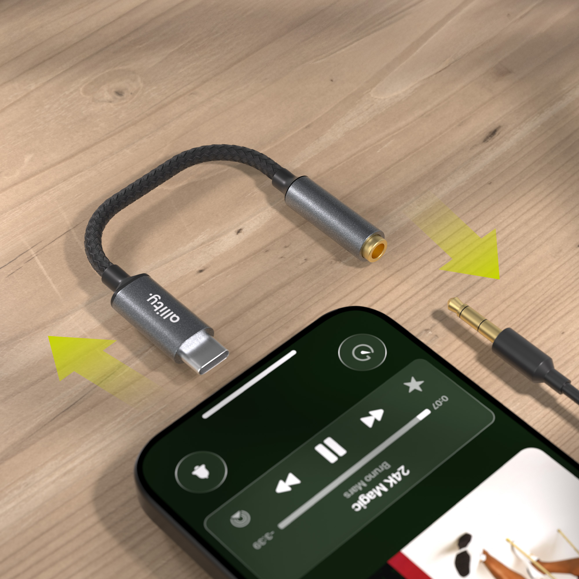 Adapter USB-C na 3,5 mm obok smartfona odtwarzającego muzykę.