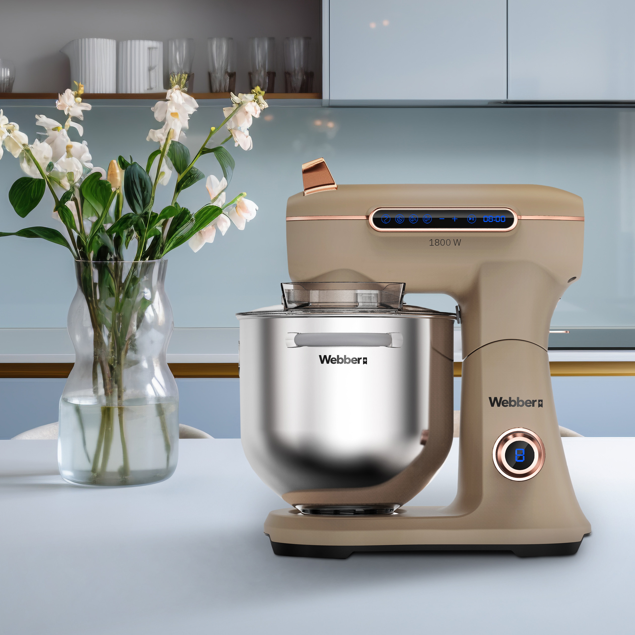 Beżowy robot kuchenny z srebrną misą i bukietem kwiatów.