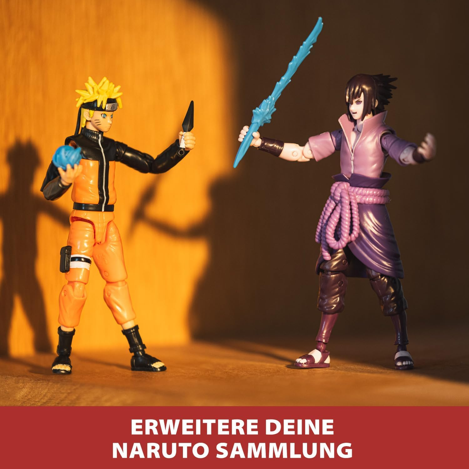 Naruto und Sasuke Actionfiguren im Kampf, eine hält einen blauen Ball, die andere ein Schwert.