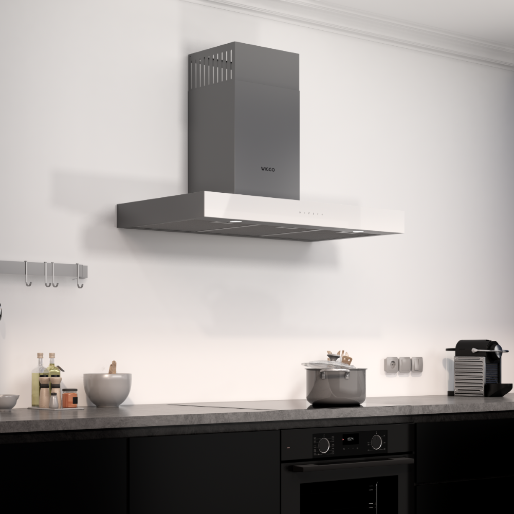 Une cuisine moderne avec hotte aspirante, plaque de cuisson et meubles bas noirs.