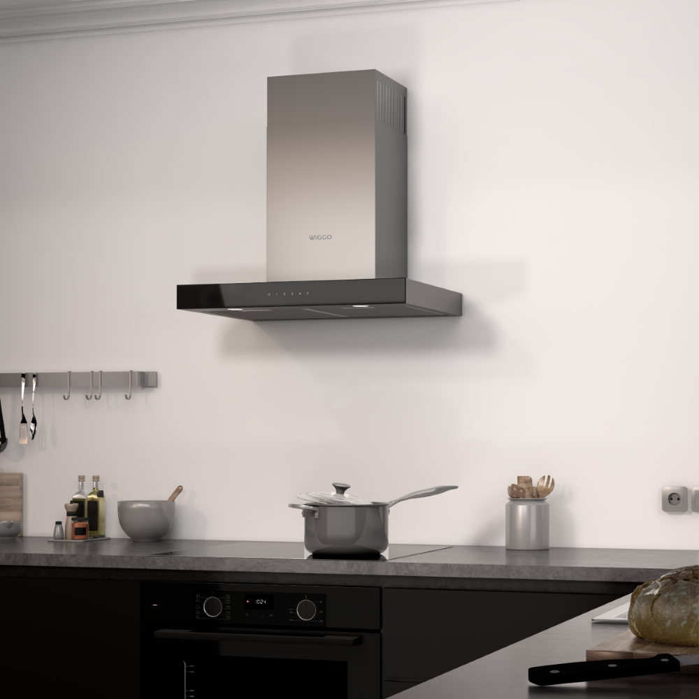 A range hood over a stovetop with a pot. Kitchen utensils hang on the wall.
