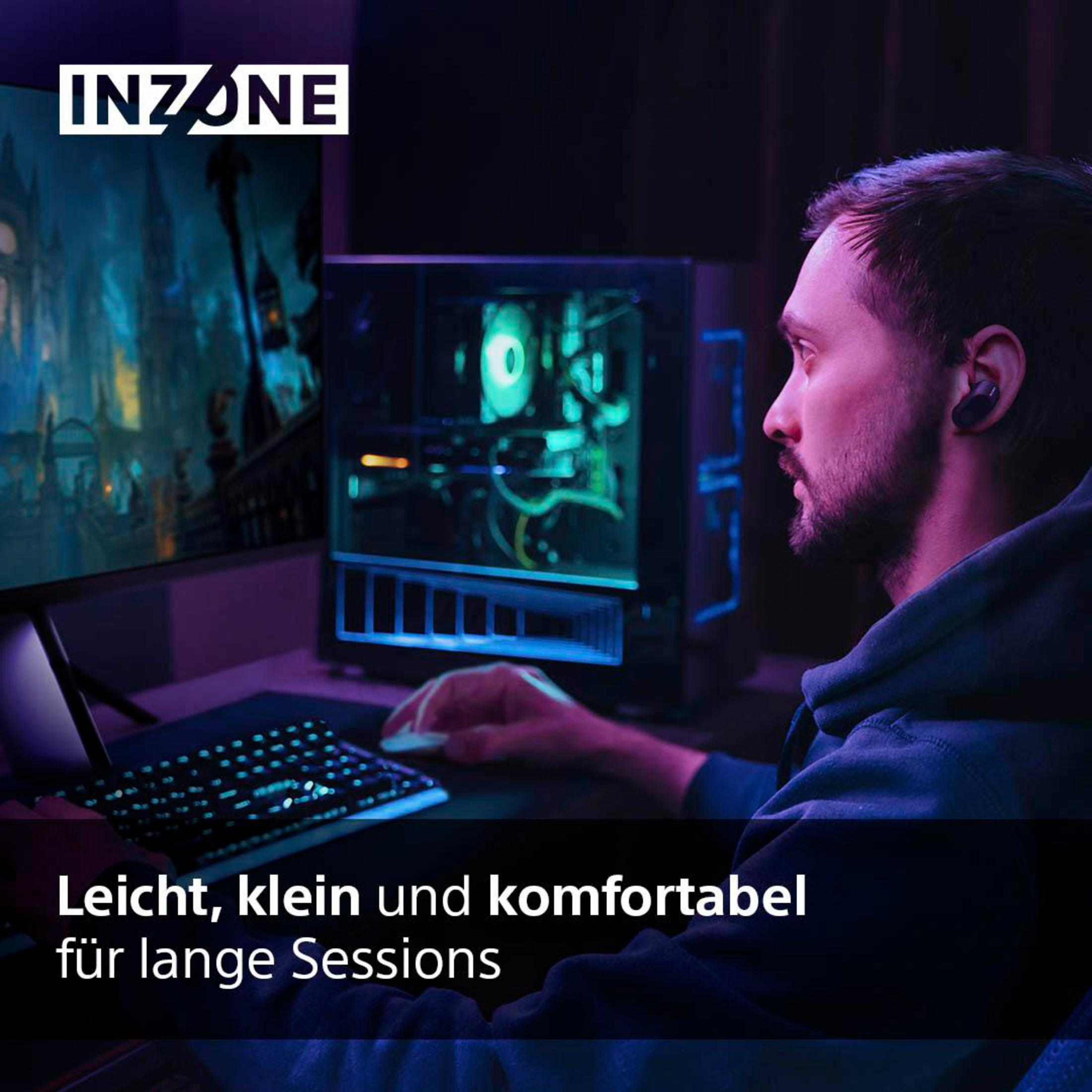 Man plays video games with gaming PC, monitor, and keyboard.